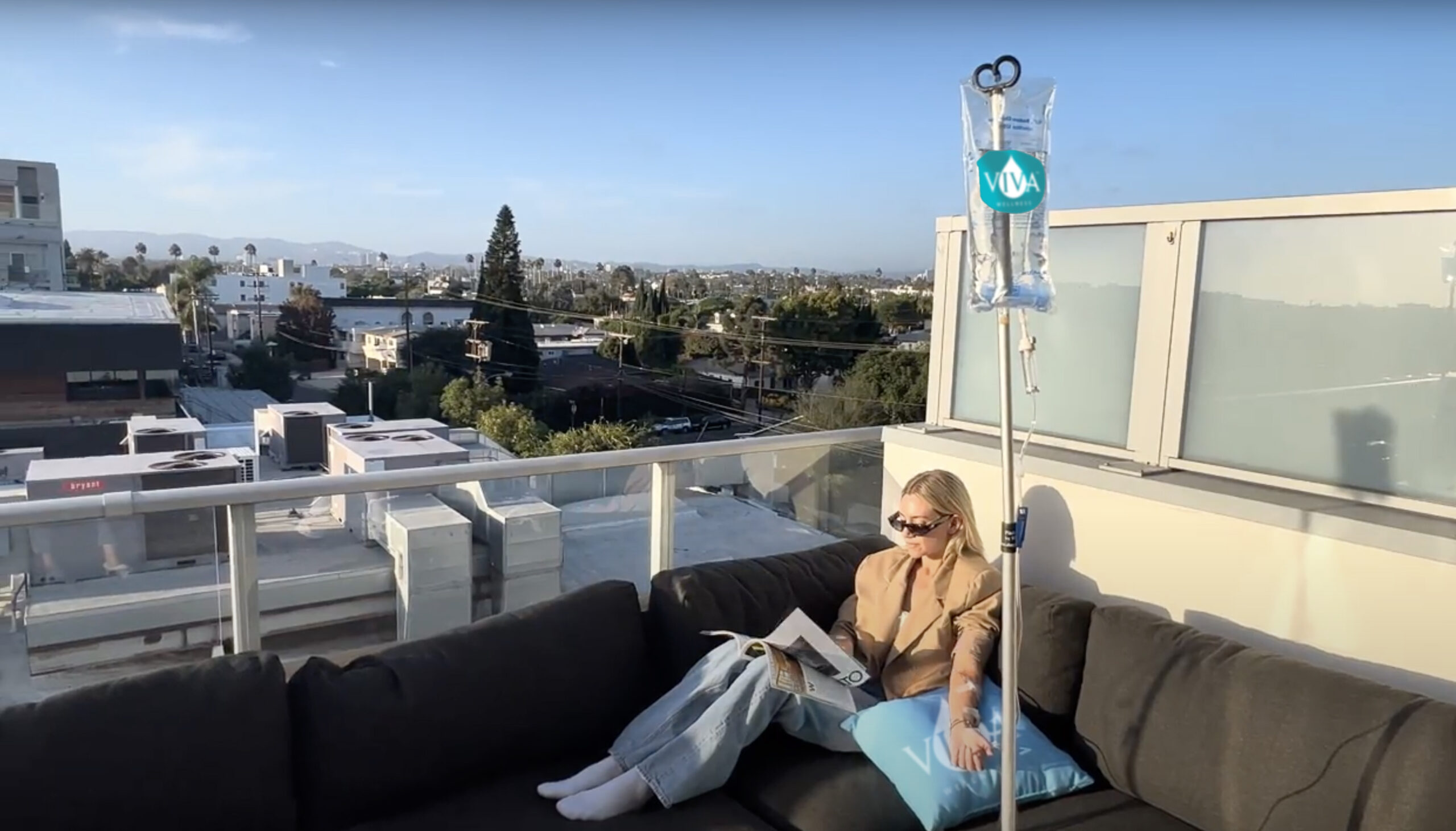 Client relaxing on a rooftop lounge during a Viva IV drip session